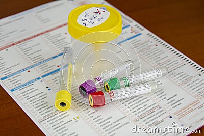 Several tubes for blood and urine samples with medical report Stock Photo